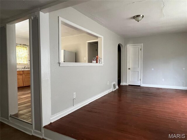 605 Abston Ave, Saint Louis, MO 63135 - empty room with wood finished floors and arched walkways