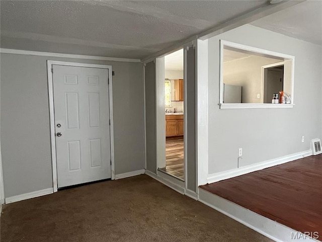 605 Abston Ave, Saint Louis, MO 63135 - spare room featuring a textured ceiling and dark colored carpet