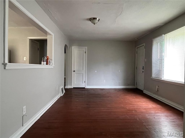 605 Abston Ave, Saint Louis, MO 63135 - spare room with arched walkways and wood finished floors