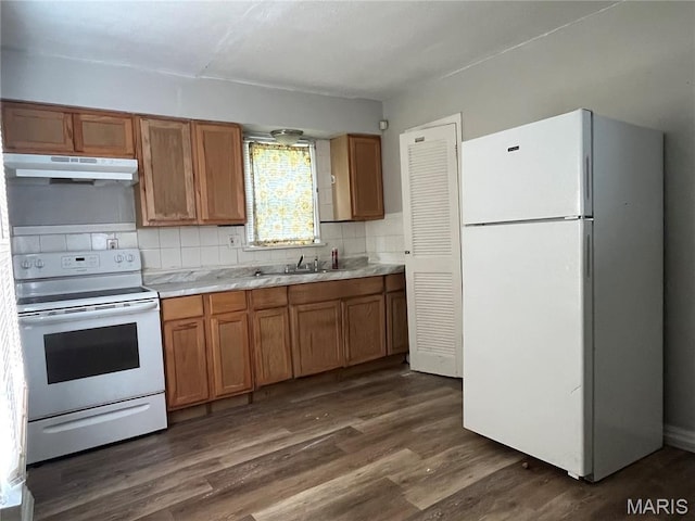 605 Abston Ave, Saint Louis, MO 63135 - kitchen featuring white appliances, under cabinet range hood, light countertops, brown cabinets, and dark wood-type flooring
