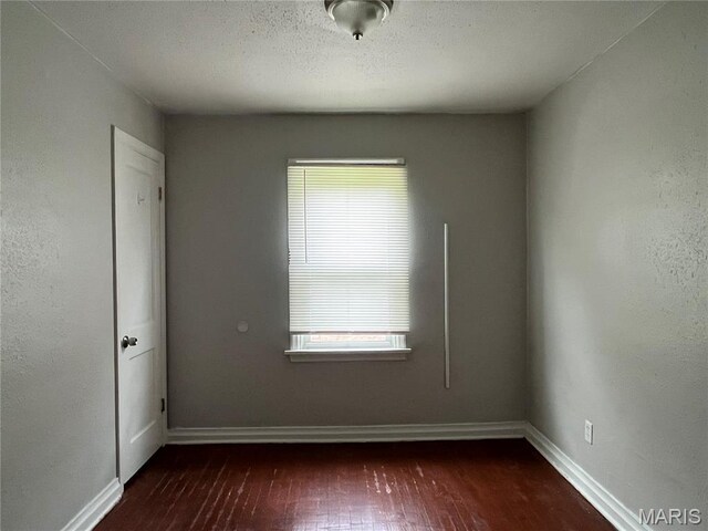 605 Abston Ave, Saint Louis, MO 63135 - unfurnished room with dark wood finished floors and baseboards