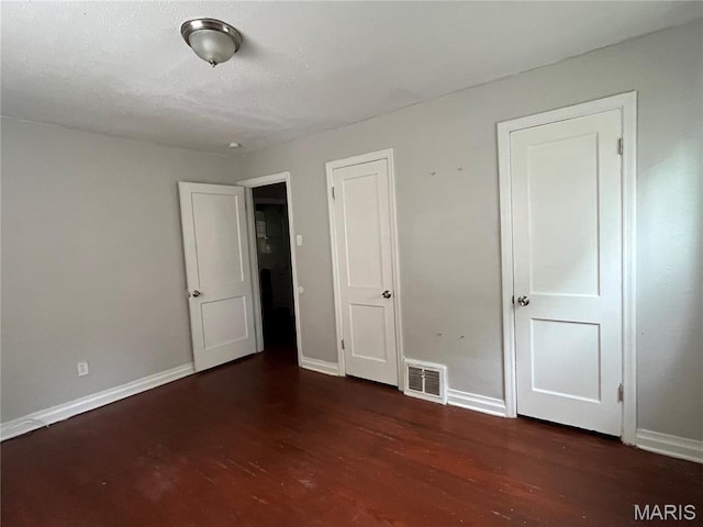 605 Abston Ave, Saint Louis, MO 63135 - unfurnished bedroom featuring wood finished floors and baseboards