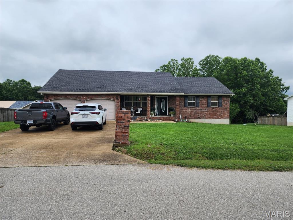 20470 London Ln, Waynesville, MO 65583 - single story home with an attached garage, driveway, a front yard, brick siding, and a shingled roof