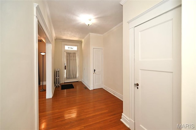 5322 Lansdowne Ave, Saint Louis, MO 63109 - entryway featuring radiator, dark wood-type flooring, and ornamental molding