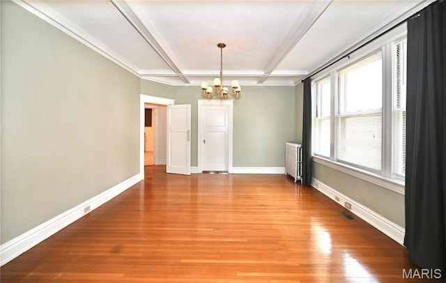 5322 Lansdowne Ave, Saint Louis, MO 63109 - spare room with a chandelier, radiator heating unit, light wood finished floors, coffered ceiling, and beam ceiling