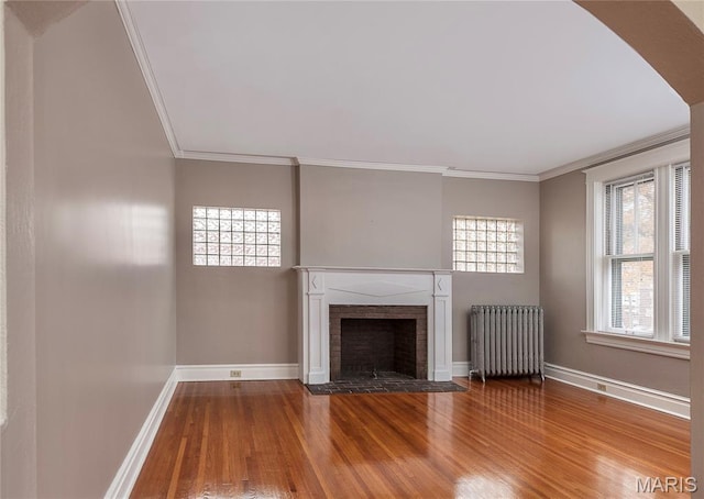 5322 Lansdowne Ave, Saint Louis, MO 63109 - unfurnished living room with radiator heating unit, wood finished floors, crown molding, and a fireplace with flush hearth