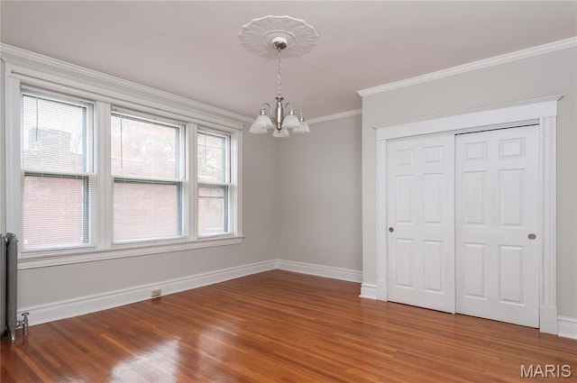 5322 Lansdowne Ave, Saint Louis, MO 63109 - unfurnished dining area with a chandelier, wood finished floors, and ornamental molding