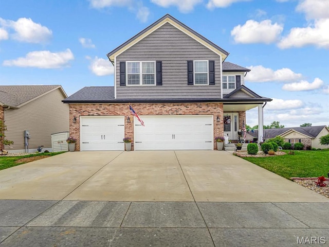 1050 Creekside Dr, Waterloo, IL 62298 - traditional home featuring brick siding, concrete driveway, a garage, and a front lawn