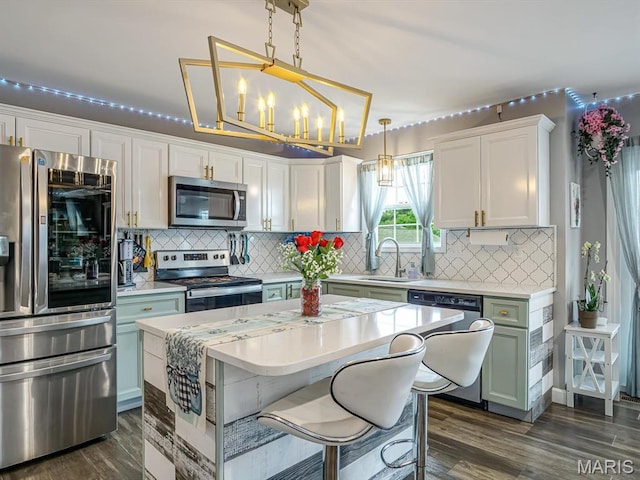 1050 Creekside Dr, Waterloo, IL 62298 - kitchen featuring appliances with stainless steel finishes, light countertops, dark wood-style flooring, and white cabinets