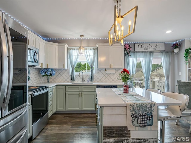 1050 Creekside Dr, Waterloo, IL 62298 - kitchen with stainless steel appliances, a chandelier, light countertops, tasteful backsplash, and recessed lighting