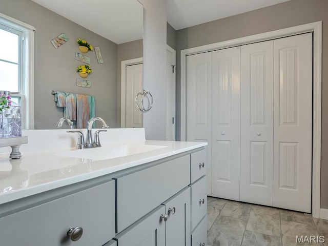 1050 Creekside Dr, Waterloo, IL 62298 - bathroom featuring a closet, vanity, and marble look tiles