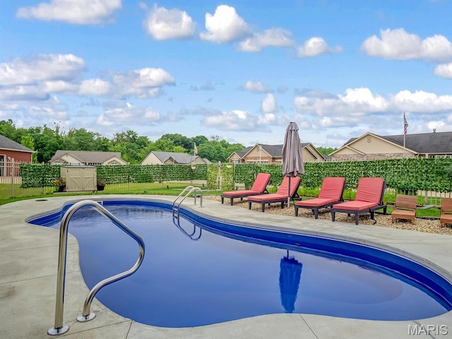 1050 Creekside Dr, Waterloo, IL 62298 - view of pool with a fenced backyard, a storage unit, and a patio