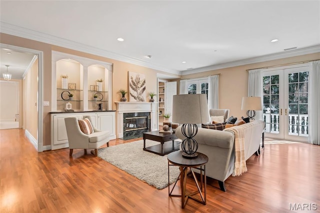 23 Topton Way Unit 2B, Clayton, MO 63105 - living room with french doors, wood finished floors, ornamental molding, recessed lighting, and a premium fireplace