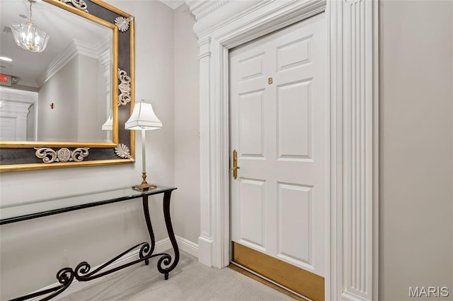 23 Topton Way Unit 2B, Clayton, MO 63105 - foyer featuring ornamental molding, carpet flooring, and a chandelier
