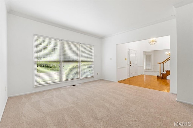 265 Timber Tree Ct, Wildwood, MO 63011 - unfurnished room with carpet, plenty of natural light, a chandelier, stairway, and crown molding