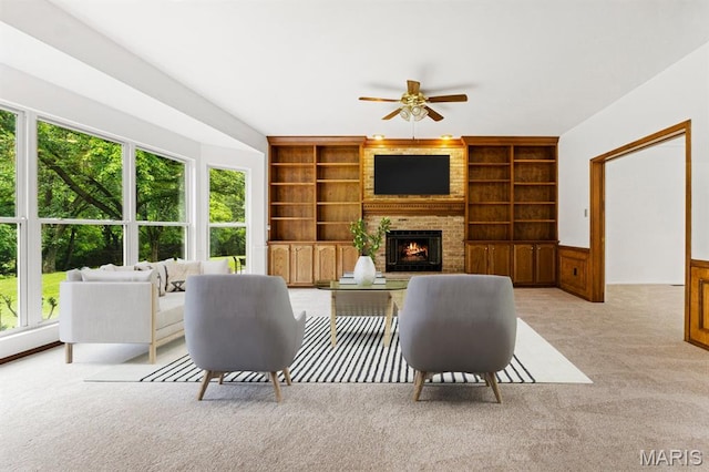 265 Timber Tree Ct, Wildwood, MO 63011 - living area featuring light colored carpet, built in shelves, a brick fireplace, and a ceiling fan