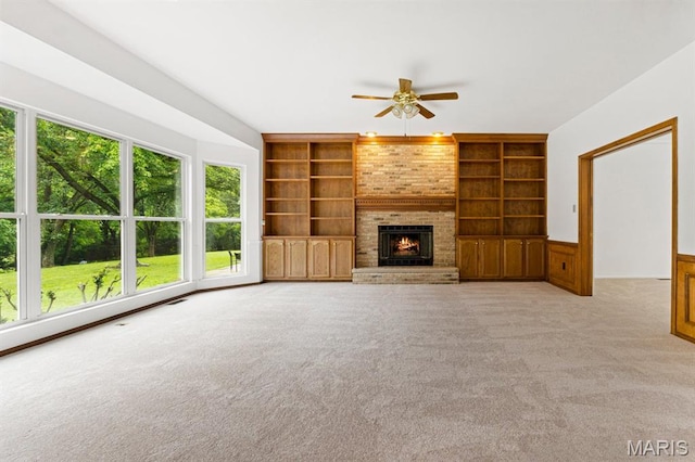 265 Timber Tree Ct, Wildwood, MO 63011 - unfurnished living room featuring built in shelves, a ceiling fan, light colored carpet, and a brick fireplace