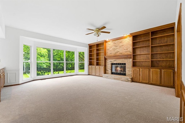 265 Timber Tree Ct, Wildwood, MO 63011 - unfurnished living room with a ceiling fan, a brick fireplace, built in features, and carpet flooring