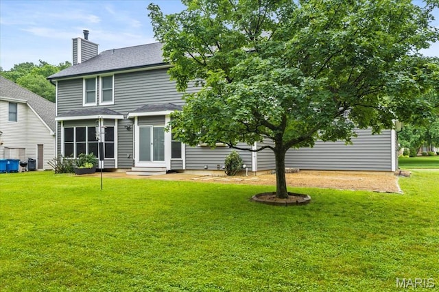 265 Timber Tree Ct, Wildwood, MO 63011 - back of property with a chimney, a lawn, a shingled roof, entry steps, and french doors
