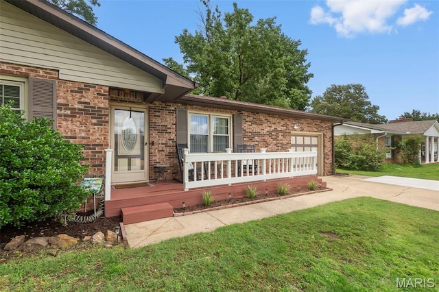1004 Willow Ln, Sikeston, MO 63801 - view of front of home with concrete driveway, brick siding, a garage, and a front yard