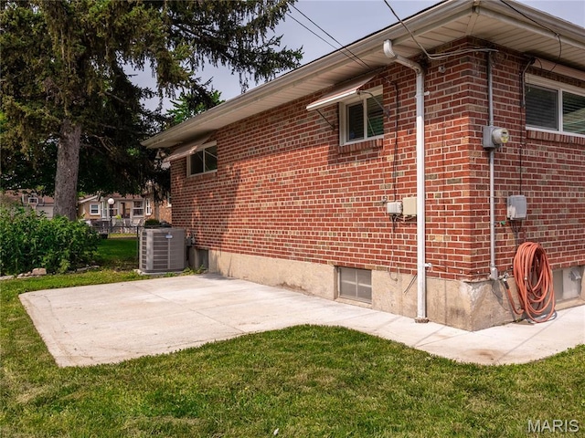 6417 Ruth Dr, Saint Louis, MO 63116 - view of side of home featuring a yard, brick siding, and a patio