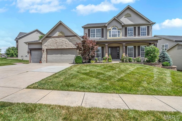 714 Oriental Lily Dr, Ofallon, MO 63366 - view of front of house featuring a garage, a front yard, concrete driveway, and board and batten siding