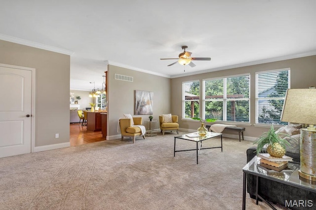714 Oriental Lily Dr, Ofallon, MO 63366 - carpeted living room featuring crown molding, ceiling fan, and a chandelier