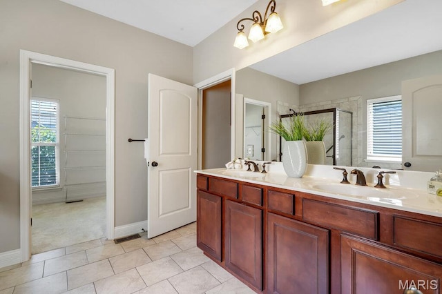 714 Oriental Lily Dr, Ofallon, MO 63366 - bathroom with a stall shower, healthy amount of natural light, double vanity, and tile patterned floors