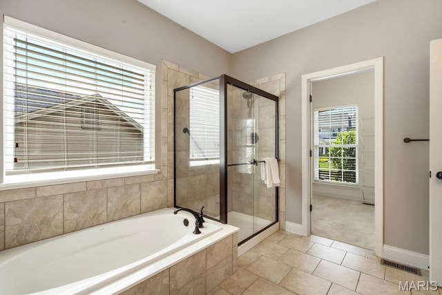 714 Oriental Lily Dr, Ofallon, MO 63366 - full bath with a garden tub, a stall shower, and tile patterned floors