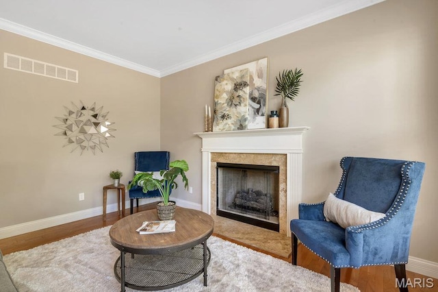 714 Oriental Lily Dr, Ofallon, MO 63366 - sitting room with crown molding, wood finished floors, and a high end fireplace