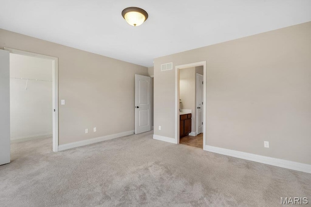 714 Oriental Lily Dr, Ofallon, MO 63366 - unfurnished bedroom with light carpet, a walk in closet, ensuite bath, and a closet