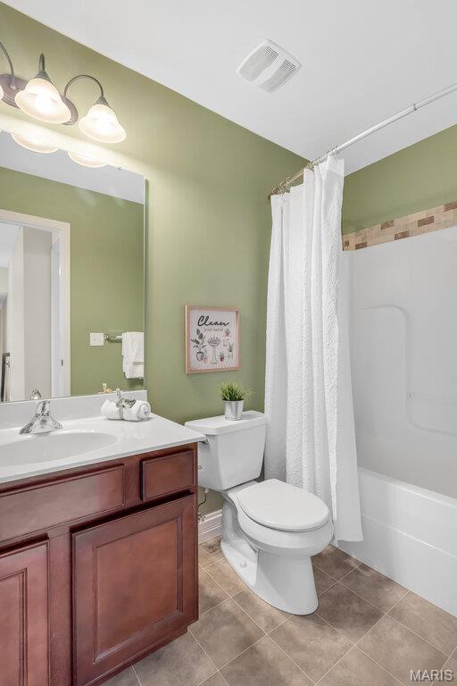 714 Oriental Lily Dr, Ofallon, MO 63366 - bathroom with vanity, tile patterned flooring, and shower / bath combo