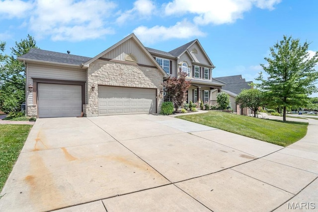 714 Oriental Lily Dr, Ofallon, MO 63366 - view of front of house featuring stone siding, a garage, concrete driveway, and a front lawn