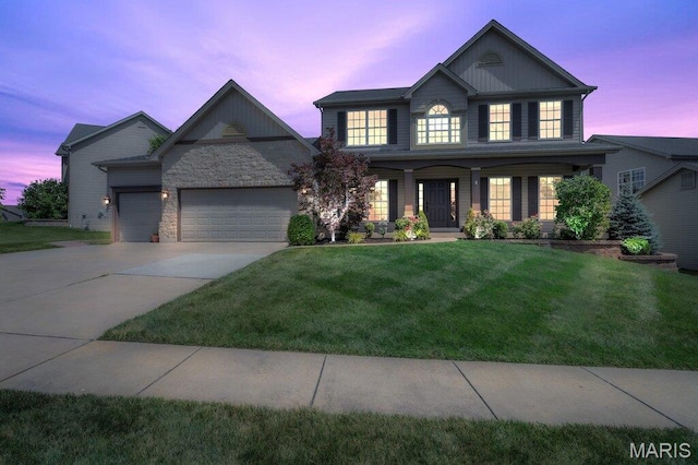 714 Oriental Lily Dr, Ofallon, MO 63366 - view of front of property with a lawn, a garage, driveway, board and batten siding, and a porch