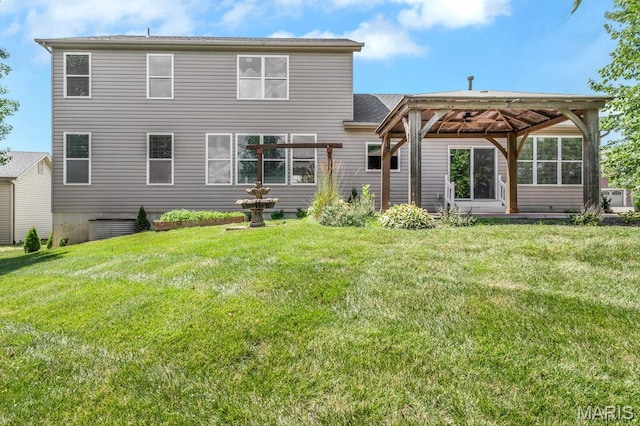 714 Oriental Lily Dr, Ofallon, MO 63366 - rear view of house featuring a gazebo and a lawn