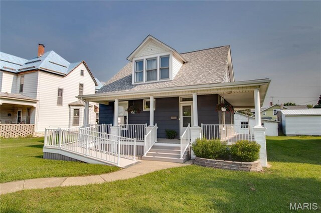 408 N N Main St, Carrollton, IL 62016 - view of front facade featuring a porch, a shingled roof, and a front lawn