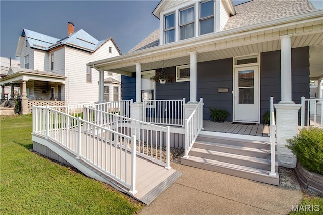 408 N N Main St, Carrollton, IL 62016 - property entrance with covered porch, roof with shingles, and a lawn