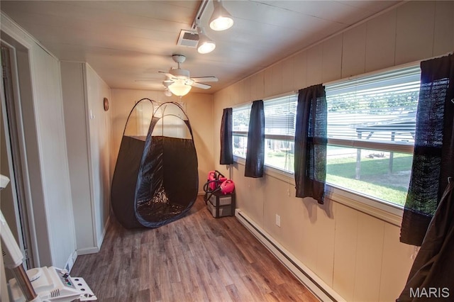 408 N N Main St, Carrollton, IL 62016 - empty room with wood finished floors, a ceiling fan, and baseboard heating