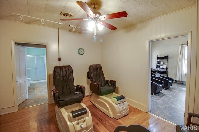 408 N N Main St, Carrollton, IL 62016 - living area featuring a ceiling fan, wood finished floors, ornamental molding, and rail lighting
