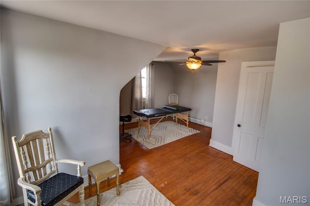 408 N N Main St, Carrollton, IL 62016 - living area featuring a ceiling fan, a baseboard heating unit, and wood finished floors