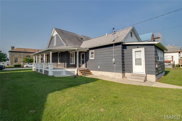 408 N N Main St, Carrollton, IL 62016 - back of property featuring entry steps, covered porch, and a lawn