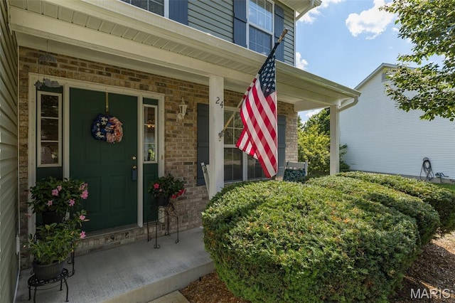 24 Adventura Dr, Festus, MO 63028 - doorway to property with covered porch and brick siding