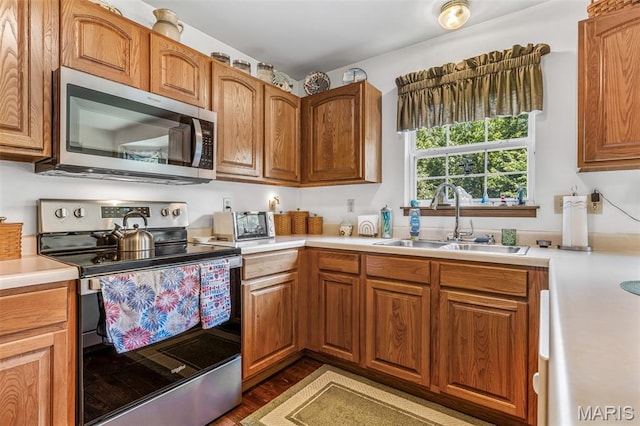 24 Adventura Dr, Festus, MO 63028 - kitchen with appliances with stainless steel finishes, light countertops, brown cabinets, and wood finished floors