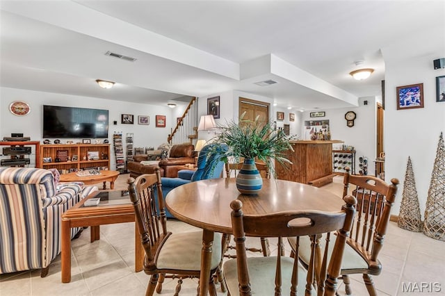 24 Adventura Dr, Festus, MO 63028 - dining space featuring light tile patterned floors, stairway, and a dry bar