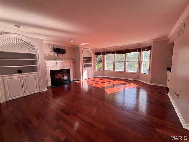 958 Kinsale Dr, Manchester, MO 63021 - unfurnished living room featuring a fireplace, crown molding, wood finished floors, and built in features