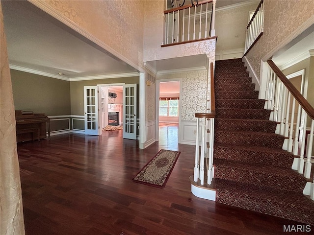 958 Kinsale Dr, Manchester, MO 63021 - stairs featuring crown molding, french doors, wood finished floors, wainscoting, and a high ceiling