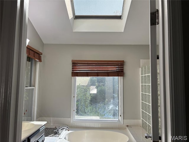 958 Kinsale Dr, Manchester, MO 63021 - bathroom featuring a garden tub, vanity, and a skylight