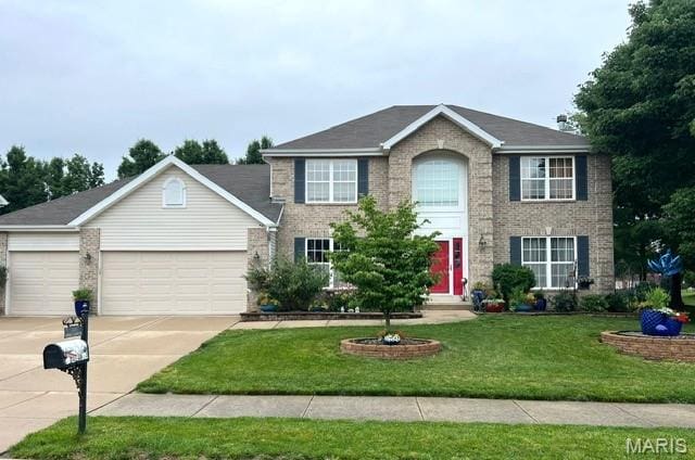 2235 Arnold Palmer Dr, Belleville, IL 62220 - colonial inspired home with brick siding, concrete driveway, a garage, and a front lawn