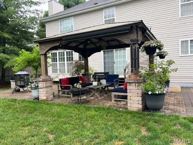2235 Arnold Palmer Dr, Belleville, IL 62220 - rear view of property featuring a gazebo, outdoor lounge area, a patio, and a chimney