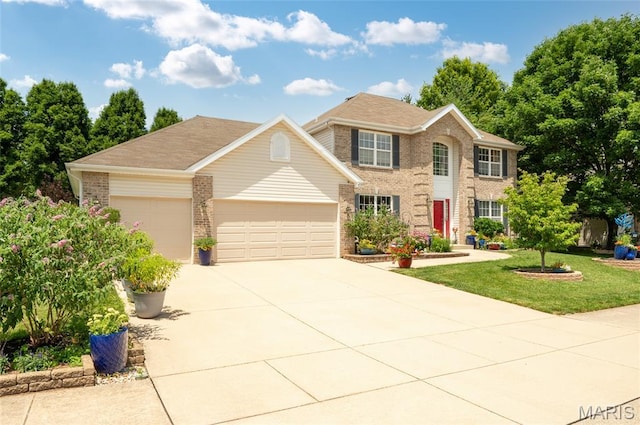 2235 Arnold Palmer Dr, Belleville, IL 62220 - colonial home featuring brick siding, a garage, concrete driveway, and a front yard